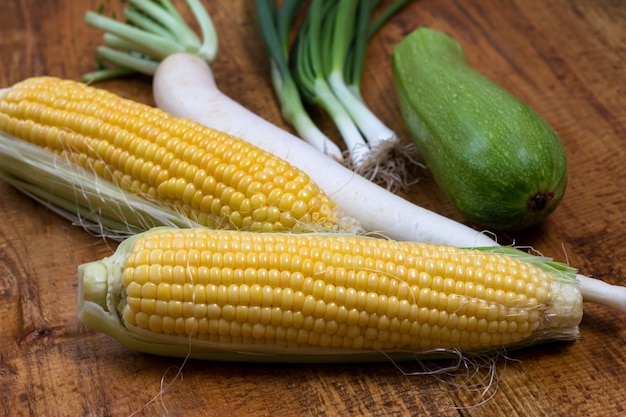 An ear of corn isolated on a wooden background