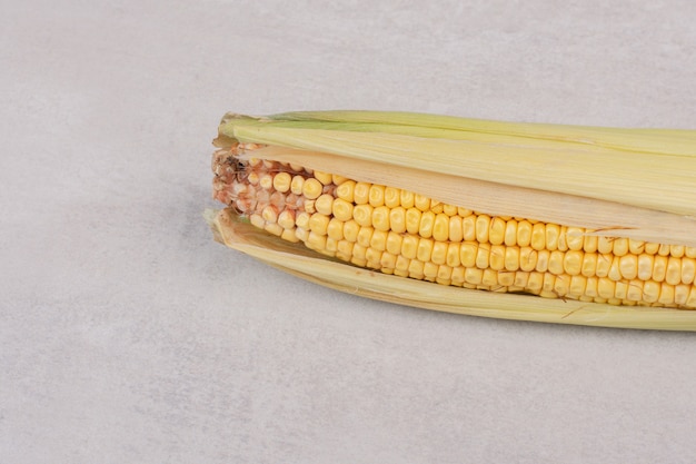 Ear of fresh corn on white.