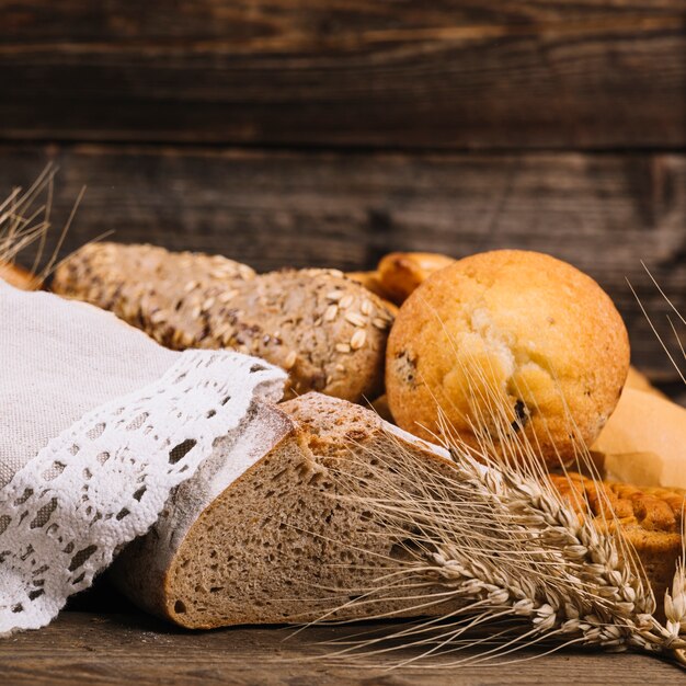 Ear of wheat with baked bread on wooden table