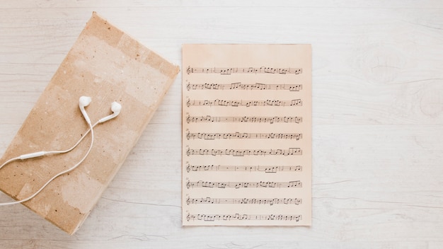 Earphones near old sheet music