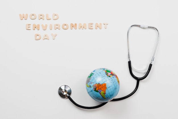 Earth over stethoscope and text world environment day 