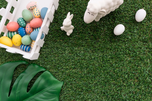 Free photo easter background with colored eggs, bunny and sheep