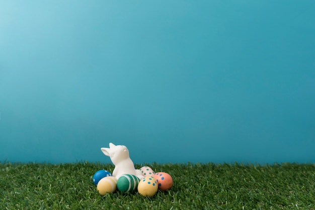 Free photo easter background with colored eggs and rabbit