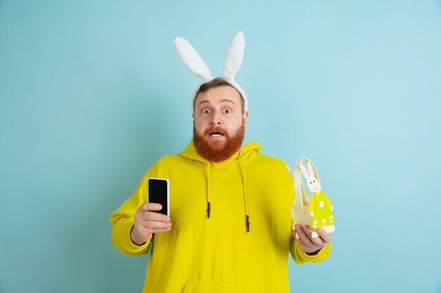 Easter bunny man with bright emotions on blue