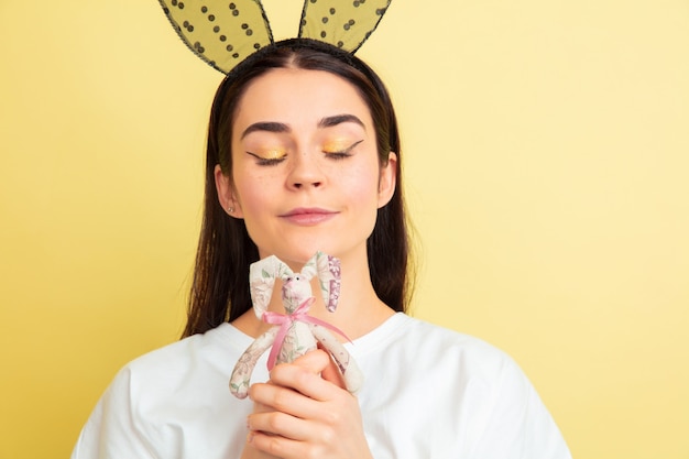 Easter bunny woman with bright emotions on yellow