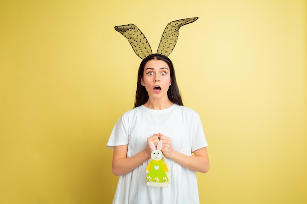 Easter bunny woman with bright emotions on yellow