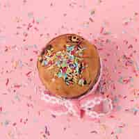 Free photo easter cake with bright sprinkles on table