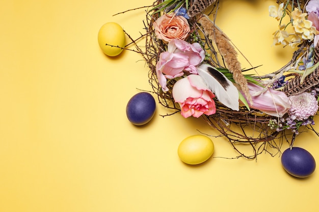 Easter card. Painted Easter eggs in nest on yellow