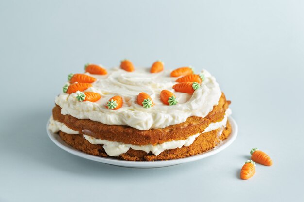 Easter carrot cake with frosting on blue background