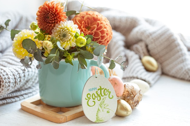 Easter composition with a bouquet of flowers and eggs on a blurred background