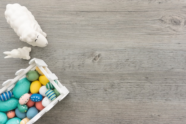 Easter composition with colored eggs, rabbit and sheep