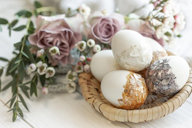 Easter composition with decorative eggs and flowers closeup