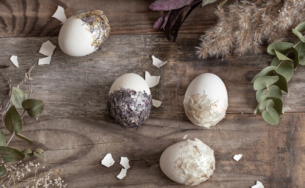 Easter composition with decorative eggs on a wooden surface copy space.