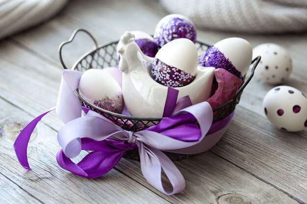 Easter composition with eggs decorated with purple sparkles
