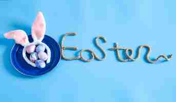 Free photo easter creative inscription on a blue background.