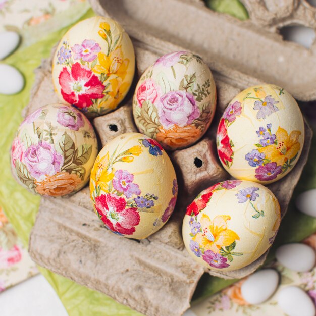 Easter eggs in container near napkins