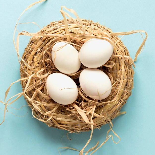 Easter eggs in hay basket top view