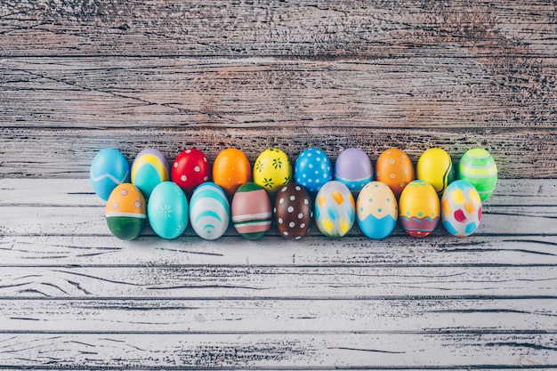 Easter eggs on light wooden background.