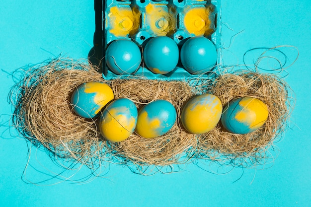 Easter eggs in nests near rack on table