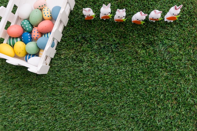 Easter eggs and rabbits on grass surface