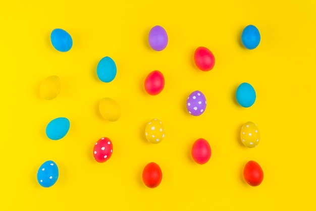 Easter eggs scattered on yellow table