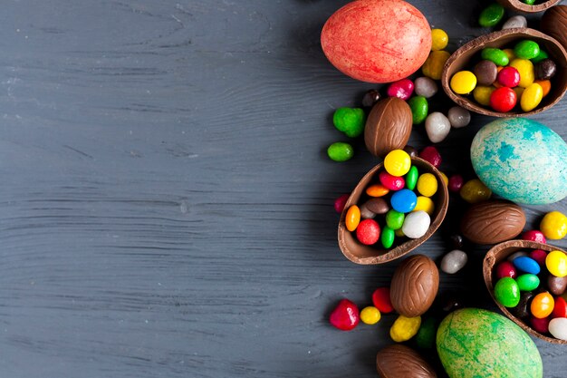 Easter eggs and sweets on gray