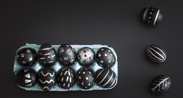 Easter eggs in tray on black isolated table