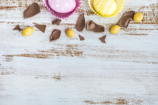 Easter eggs with cracked chocolate on table