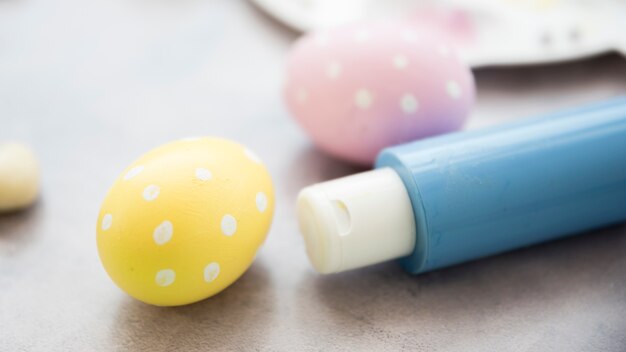 Free photo easter eggs with glue stick on table