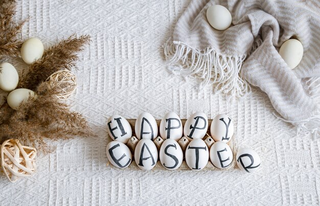 Easter eggs with the inscription happy Easter, holiday decor . Still life with an Easter cozy mood.