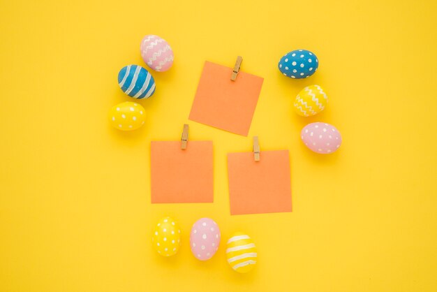 Easter eggs with small blank papers on table