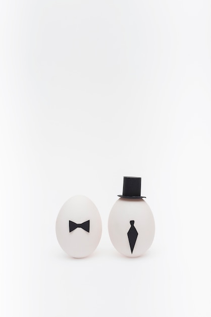 Free photo easter eggs with tie and bow tie on table