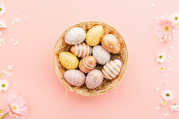 Easter Flat Lay of Eggs with flowers on pink