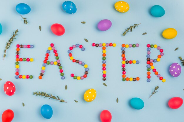 Easter inscription from candies with colored eggs 