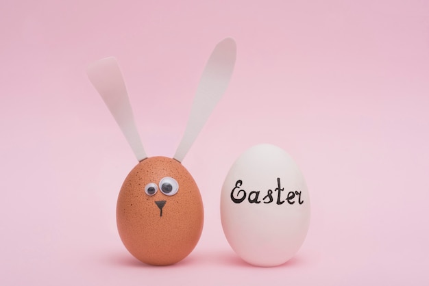 Easter inscription on white egg with bunny 