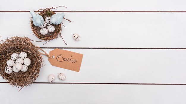 Easter inscription with quail eggs in nests