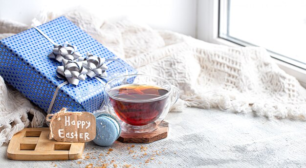 Easter mood, Cozy Easter still life with decor by the window. Morning tea with dessert.