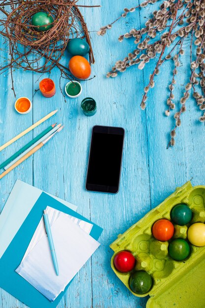 Easter in office workplace on blue wooden table