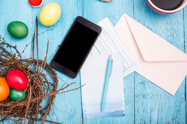 Easter in office workplace on blue wooden table