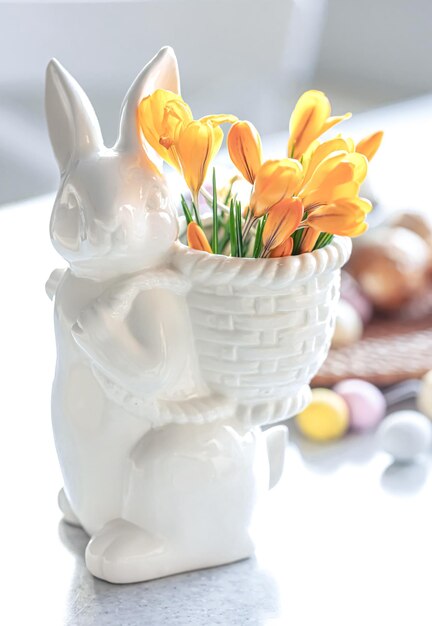 Easter still life with a ceramic hare eggs and flowers
