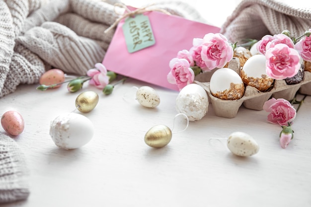 Easter still life with Easter eggs, fresh flowers and decorative elements close up.