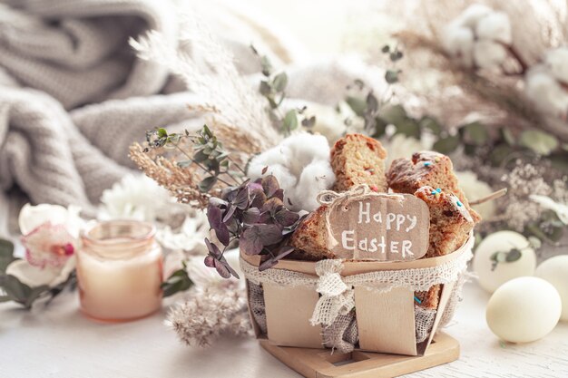 Easter still life with pieces of festive cupcake, eggs and flowers. Easter holiday concept.