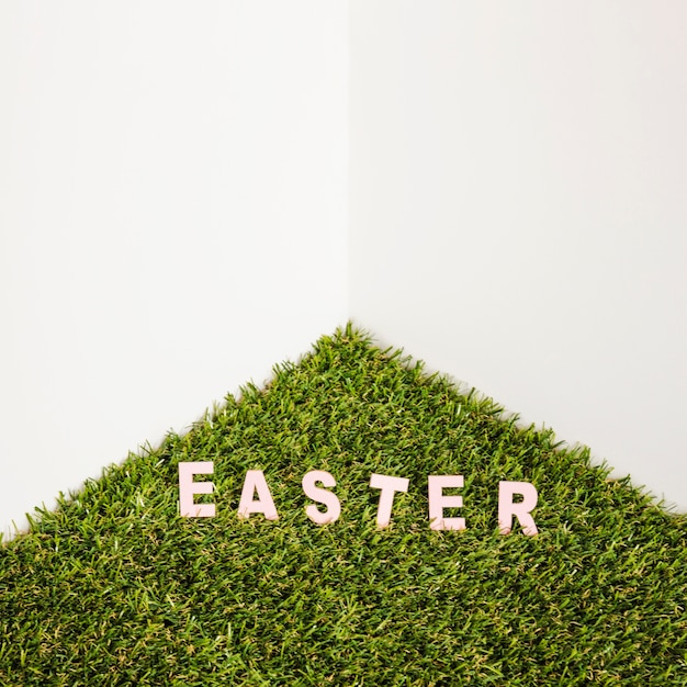 Free photo easter word on artificial grass