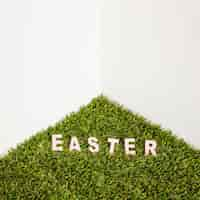 Free photo easter word on artificial grass