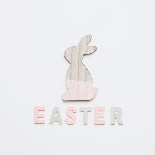 Free photo easter word and painted bunny figurine