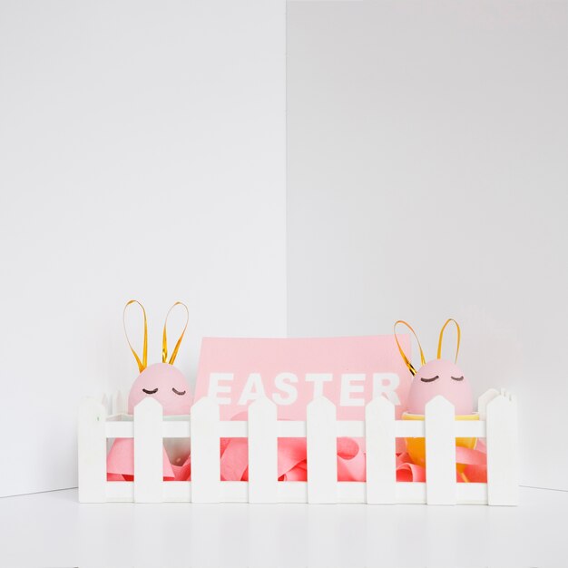 Free photo easter word and pink rabbit eggs