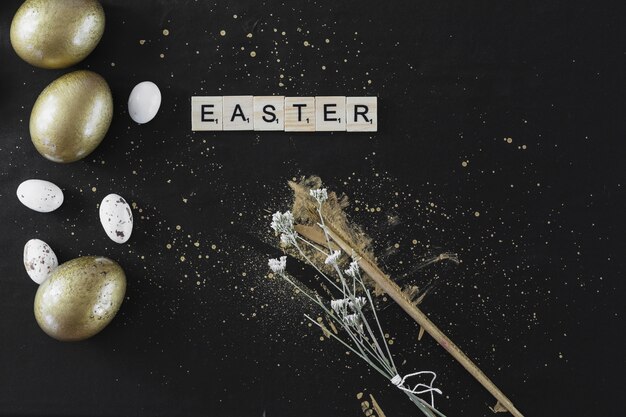 Easter writing near eggs and flowers