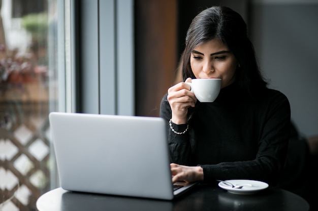 Eastern woman in a cafe