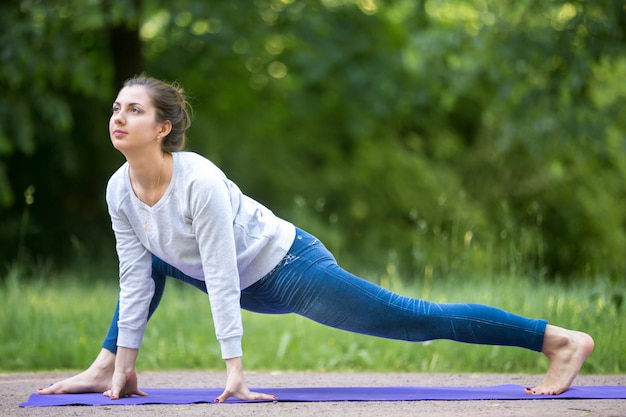 Easy variation of utthan pristhasana pose in park alley