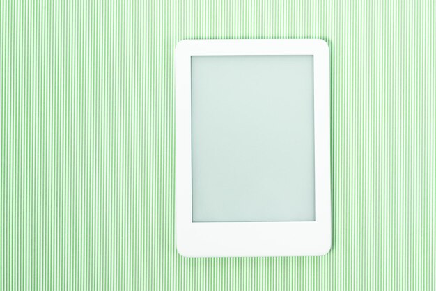 Ebook reader over green striped background